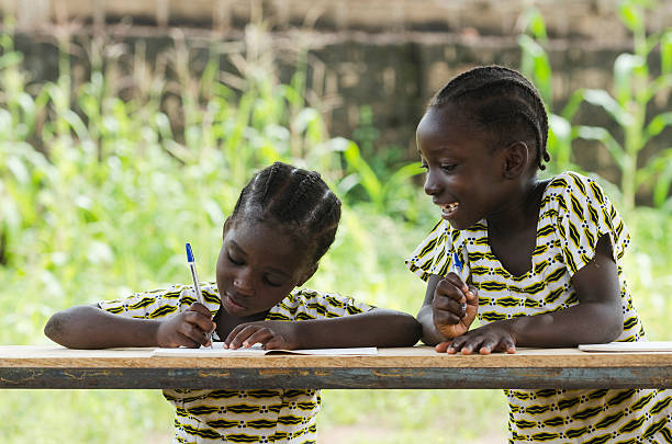 Concentration While Doing Homework - African Girls at School stock photo