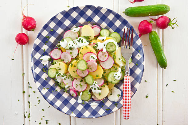 Potato salad with fresh cucumber stock photo