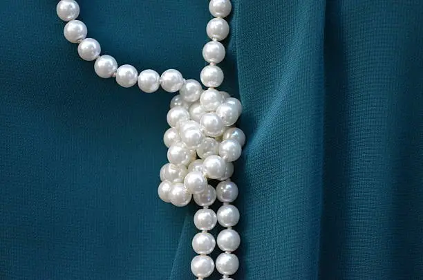 String of pearls on a dark green dress