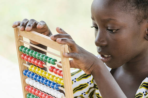 istock Learning to Count: African Girl Playing with a Toy 492571830