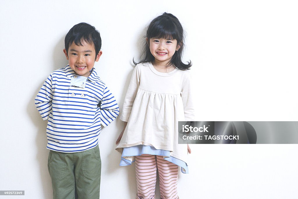 Boy and girl standing still with smile Child Stock Photo