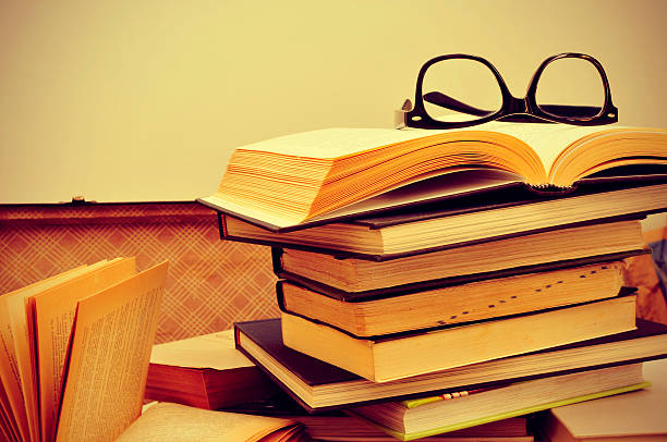 istock books and eyeglasses in an old suitcase 492572391