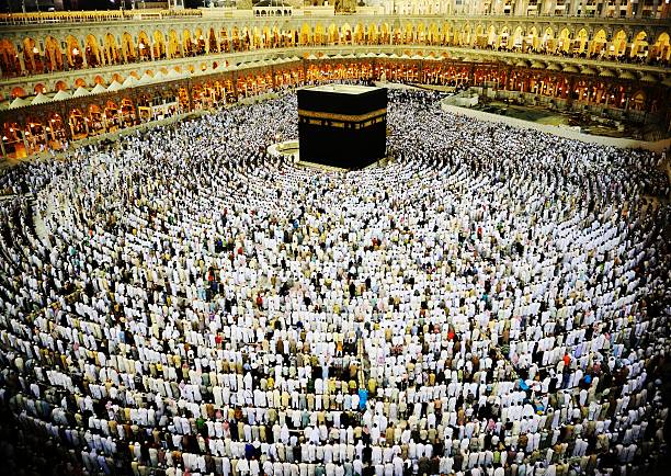 Kaaba in Mecca, Muslim people praying together at holy place stock photo