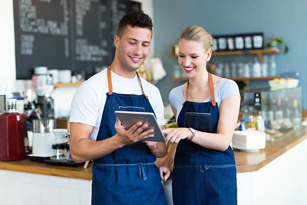 istock Man and woman working in coffee shop 492574668