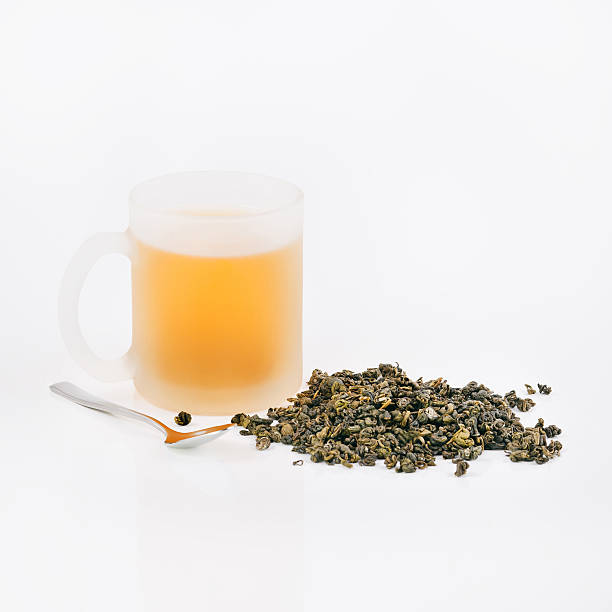 istock Cup of green tea, green tea leaves 492575386
