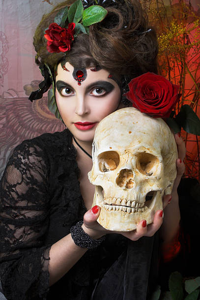 istock Woman with roses and skull 492575403