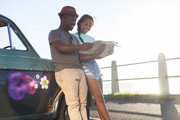 istock African hipster friends reading a map on holiday 492575415