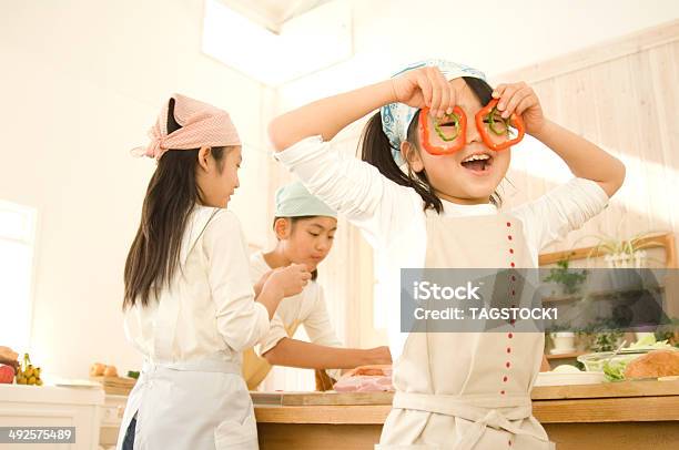 Japanese Girls Cooking Playing With Paprica In Kitchen Stock Photo - Download Image Now