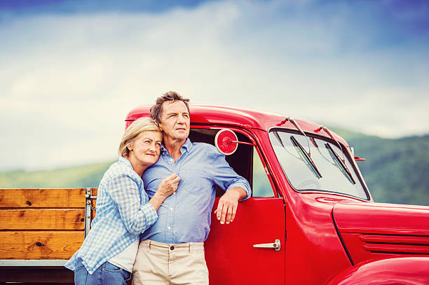 istock Senior couple with red car 492576840