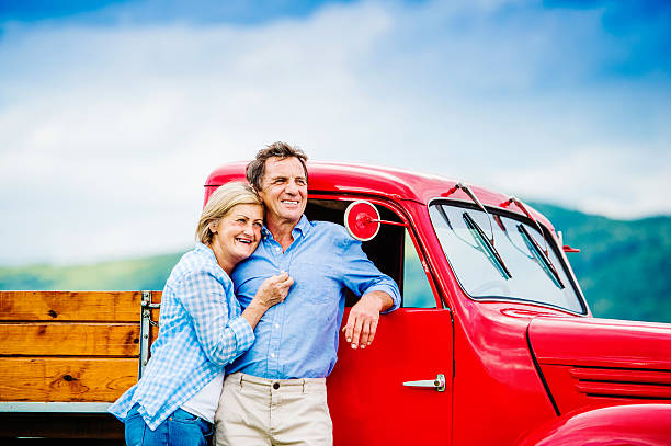 istock Senior couple with red car 492576916