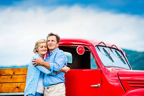 istock Senior couple with red car 492577022