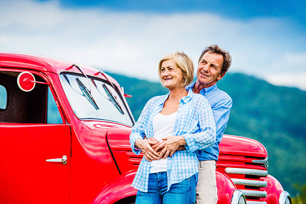 istock Senior couple with red car 492577084