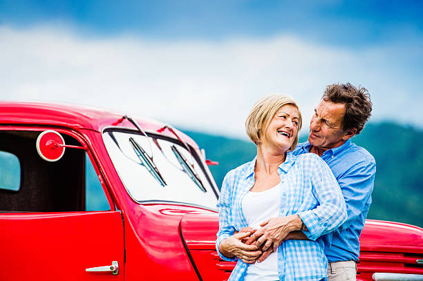 istock Senior couple with red car 492577142