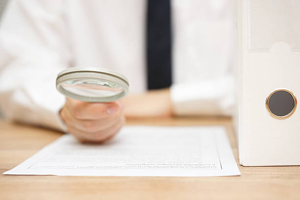 istock businessman is reviewing company documentation on workplace, due diligence concept 492577158