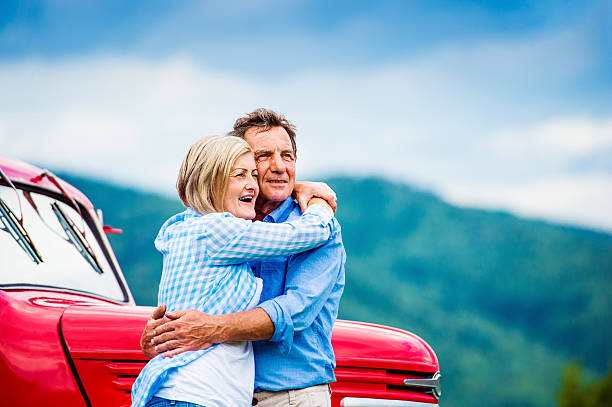 istock Senior couple with red car 492577200