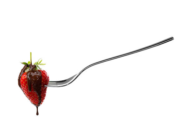 istock fork holding strawberry with chocolate sauce 492578500