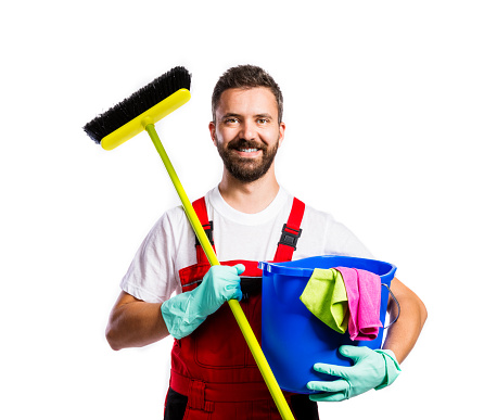 Young handsome cleaner in red overalls. Studio shot on white background