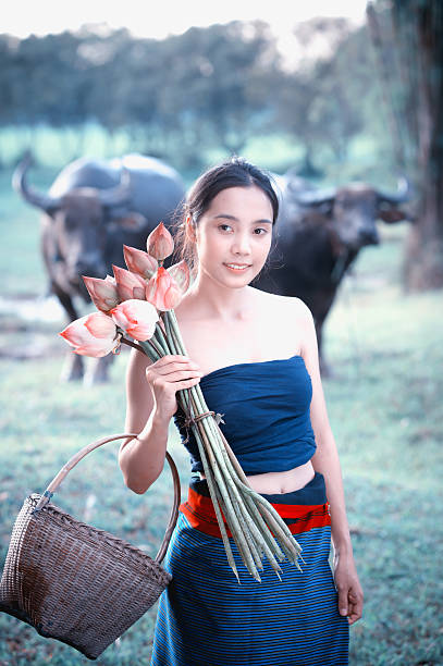 istock thai ancient young women with buffalo on rural 492580518