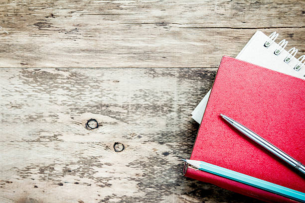 istock Back to school concept. Book, old pencils on wooden background. 492583714