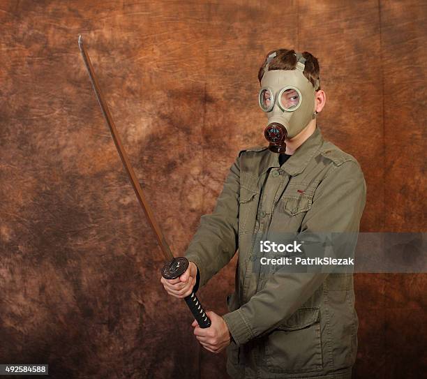 Man With Gas Mask Katana Sword On Brown Batik Background Stock Photo - Download Image Now