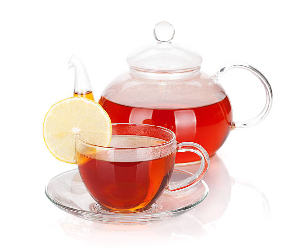 istock Glass teapot and cup of black tea with lemon slice 492585424