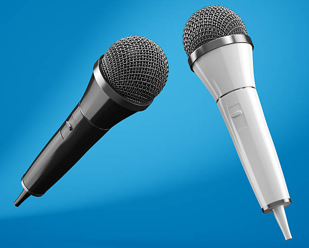 istock Black and white microphones on blue background 492585604