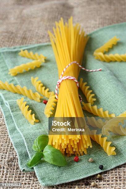 Uncooked Gluten Free Pasta Stock Photo - Download Image Now - Backgrounds, Basil, Bowl