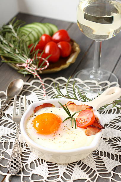 istock Breakfast on wooden tray, fried egg with bacon and vegetables 492596235