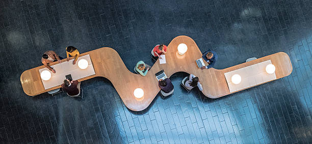 Overhead view of business meetings Panoramic overhead view of several business meetings going on in the communal area of a modern office building. viewpoint photos stock pictures, royalty-free photos & images