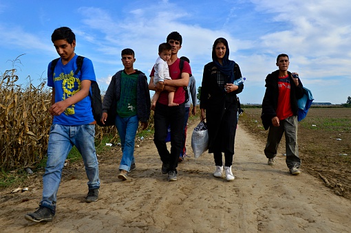 Sid,Serbia - October 4, 2015: Group of Afghan refugees leaving Serbia. They came to Sid by taxi and then they leaving Serbia and go to Croatia and then to Germany. Many of them escapes from home because of civil war.