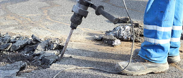 istock Road repairing works with jackhammer 492596925