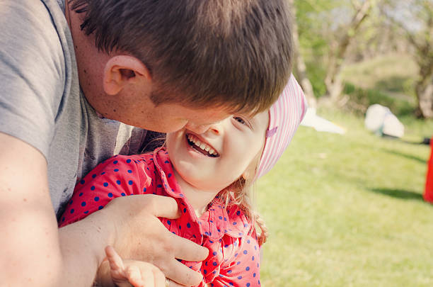 istock Father Hugging Young Daughter Outdoors 492598434
