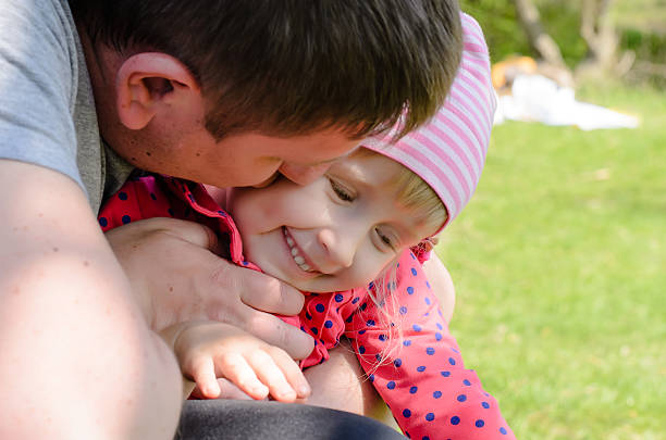 istock Father Hugging Young Daughter Outdoors 492598458