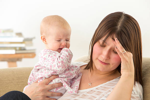 istock Tired Mother With Upset Baby 492598695