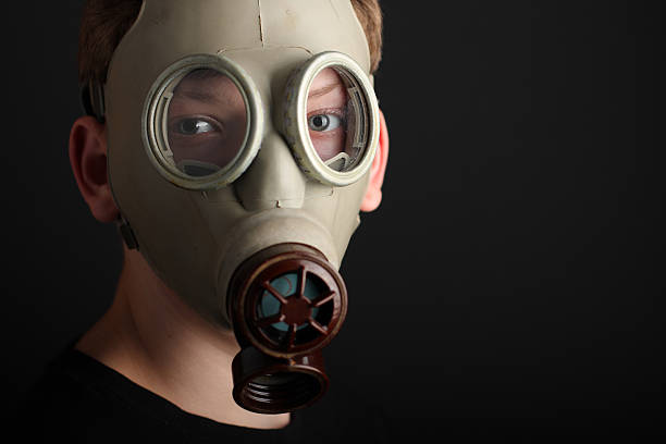 istock Man with gas mask on black  background 492598812