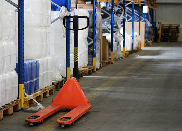 Orange pallet truck for package in the warehouse stock photo