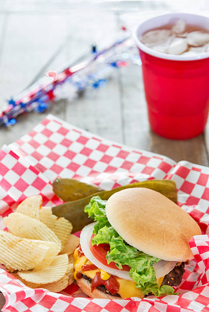 istock Loaded cheeseburger at a patriotic themed BBQ 492600875