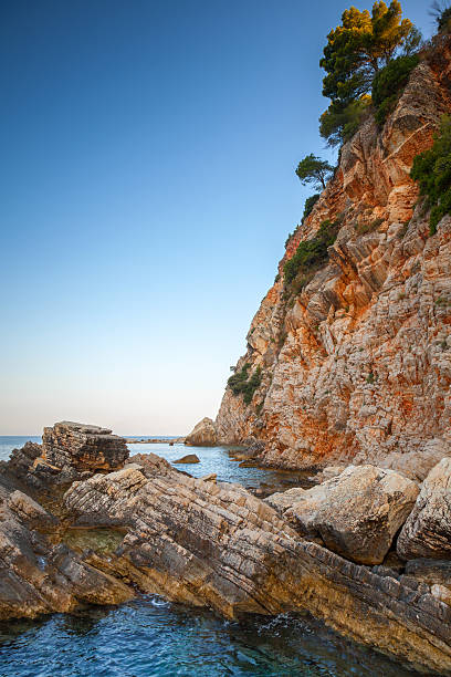 istock Red coastal rocks with pine trees. Adriatic Sea, Montenegro 492601400
