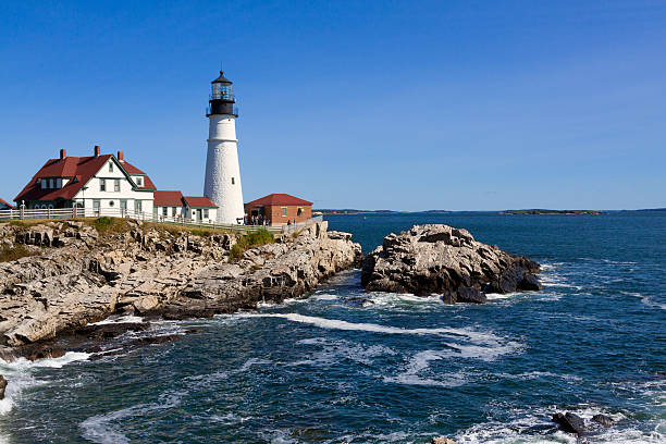 istock Portland Head Light, rocks, ocean surf, in morning. Blue sky. 492601438