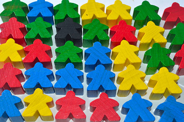 istock Little multi colour wooden human figures or meaples lying flat. 492601538