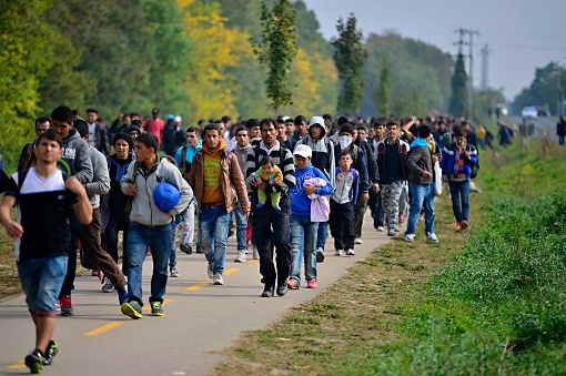 Hegyeshalom, Hungary - October 6, 2015:  Group of refugees leaving Hungary. They came to Hegyeshalom by train and then they leaving Hungary and go to Austria and then to Germany. Many of them escapes from home because of civil war.