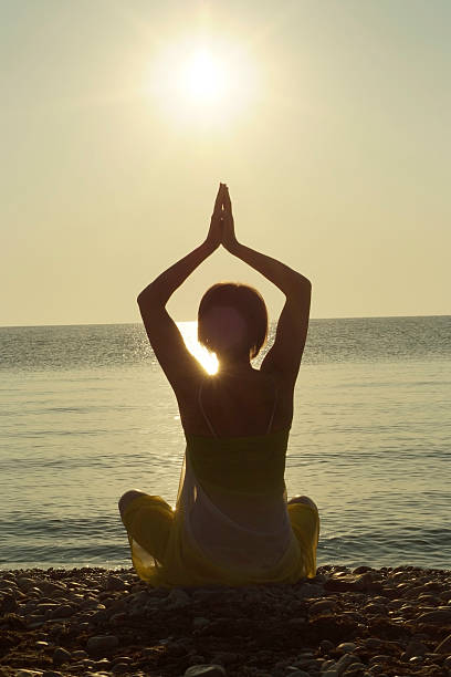 istock Silhouette of woman maditating 492602122