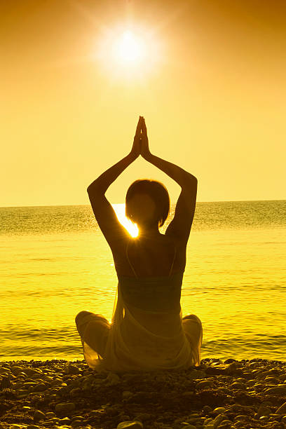 istock Silhouette of woman maditating 492602256