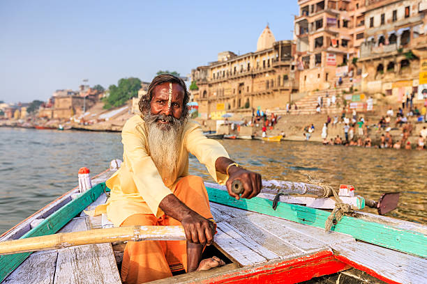 istock Sadhu rowing boat on the holy Ganges River in Varanasi 492603098