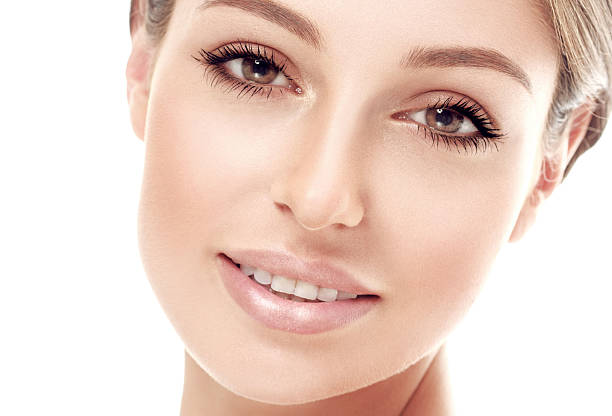 istock Beautiful woman face close up studio on white 492603334