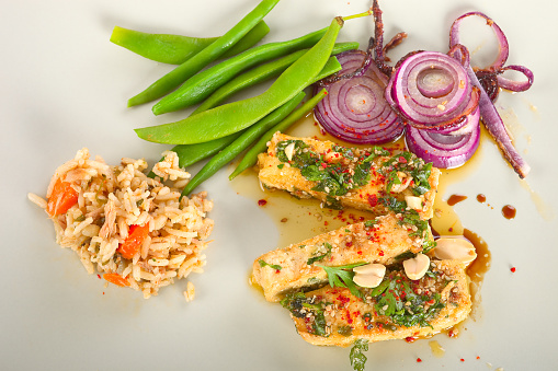 Spicy marinated tofu with green bean, red onion and rice salad.