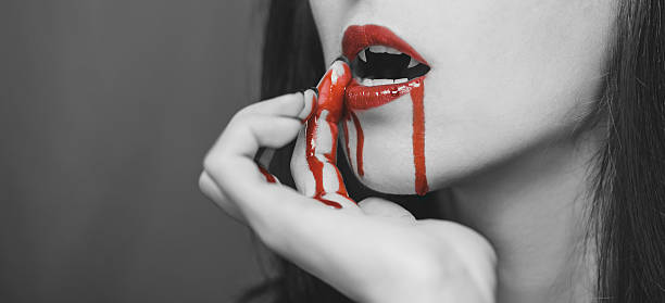 istock Vampire wipes the blood from her lips 492605498