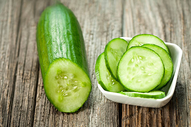 Fresh cucumber on the wooden table Fresh cucumber on the wooden table-vegetables-organic food cucumber slice stock pictures, royalty-free photos & images