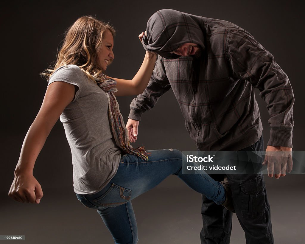 Teenage girl uses self defense skills to fight back. GIRL FIGHTS BACK SELF DEFENSE  Self-Defense Stock Photo