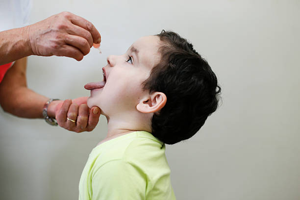 Childhood vaccination with droplet stock photo
